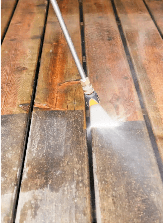 Cleaning wooden deck with pressure washer