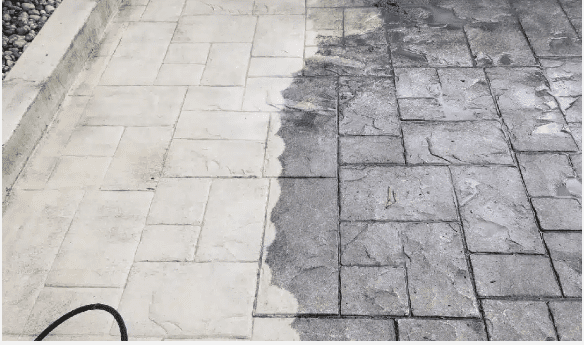 Driveway partially cleaned with power washing