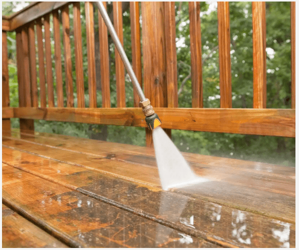 Wooden deck being pressure cleaned