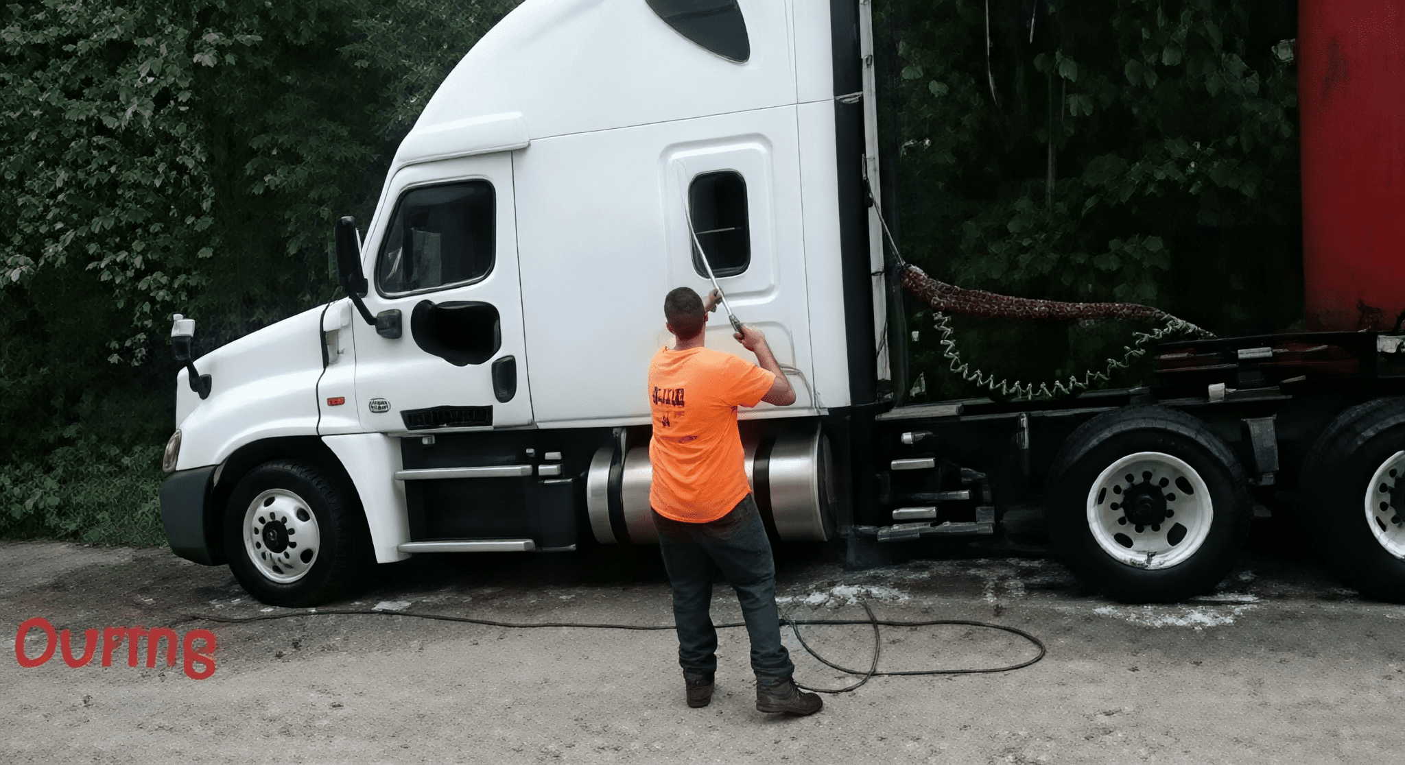 Man washing white semi-truck