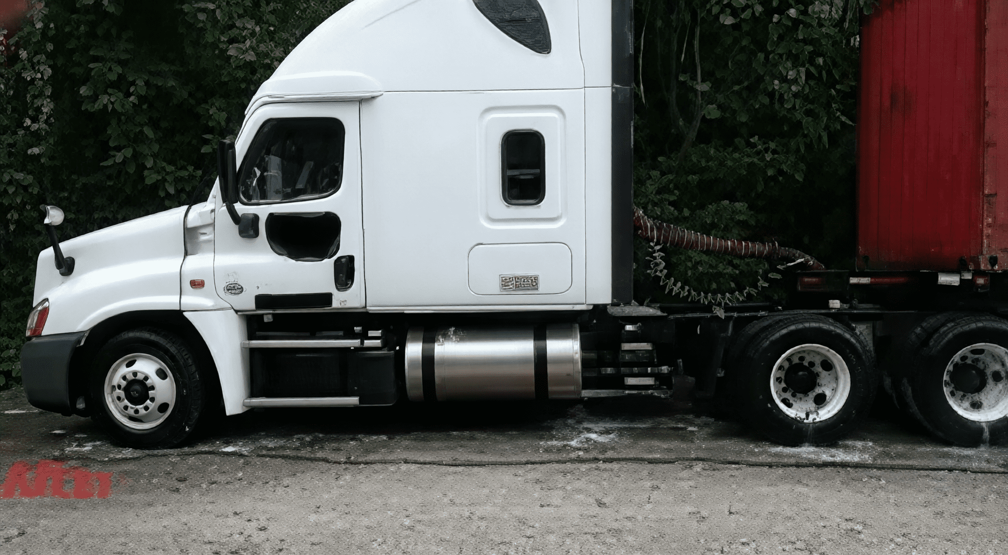 Semi-truck with red container trailer