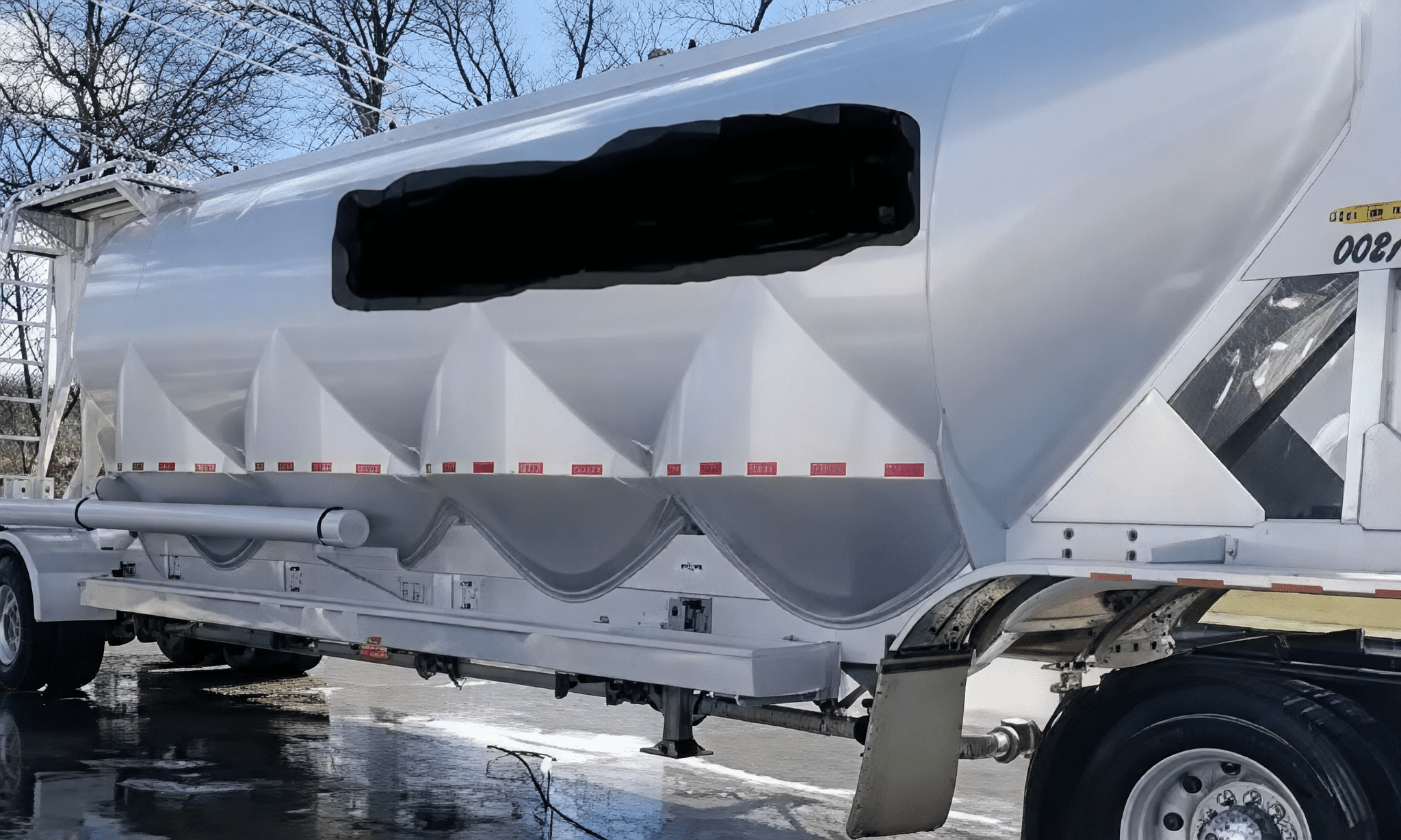 Industrial tanker on wet pavement