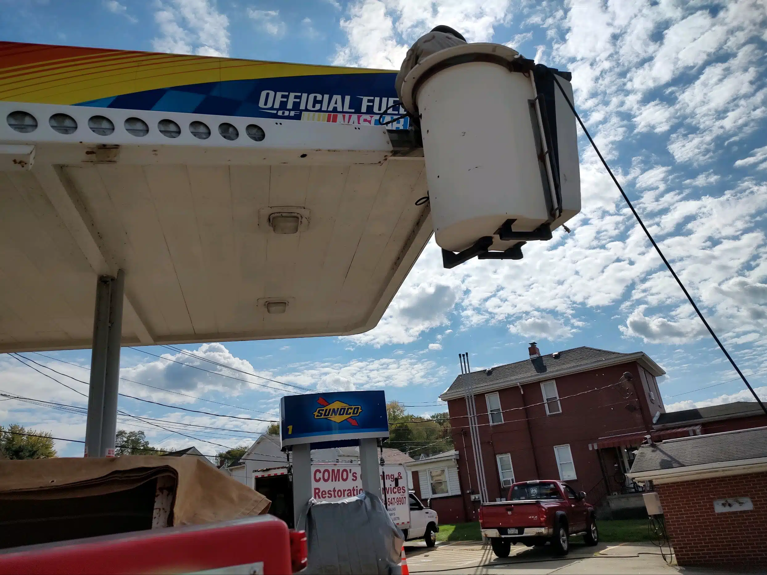 Sunoco sign beside red truck