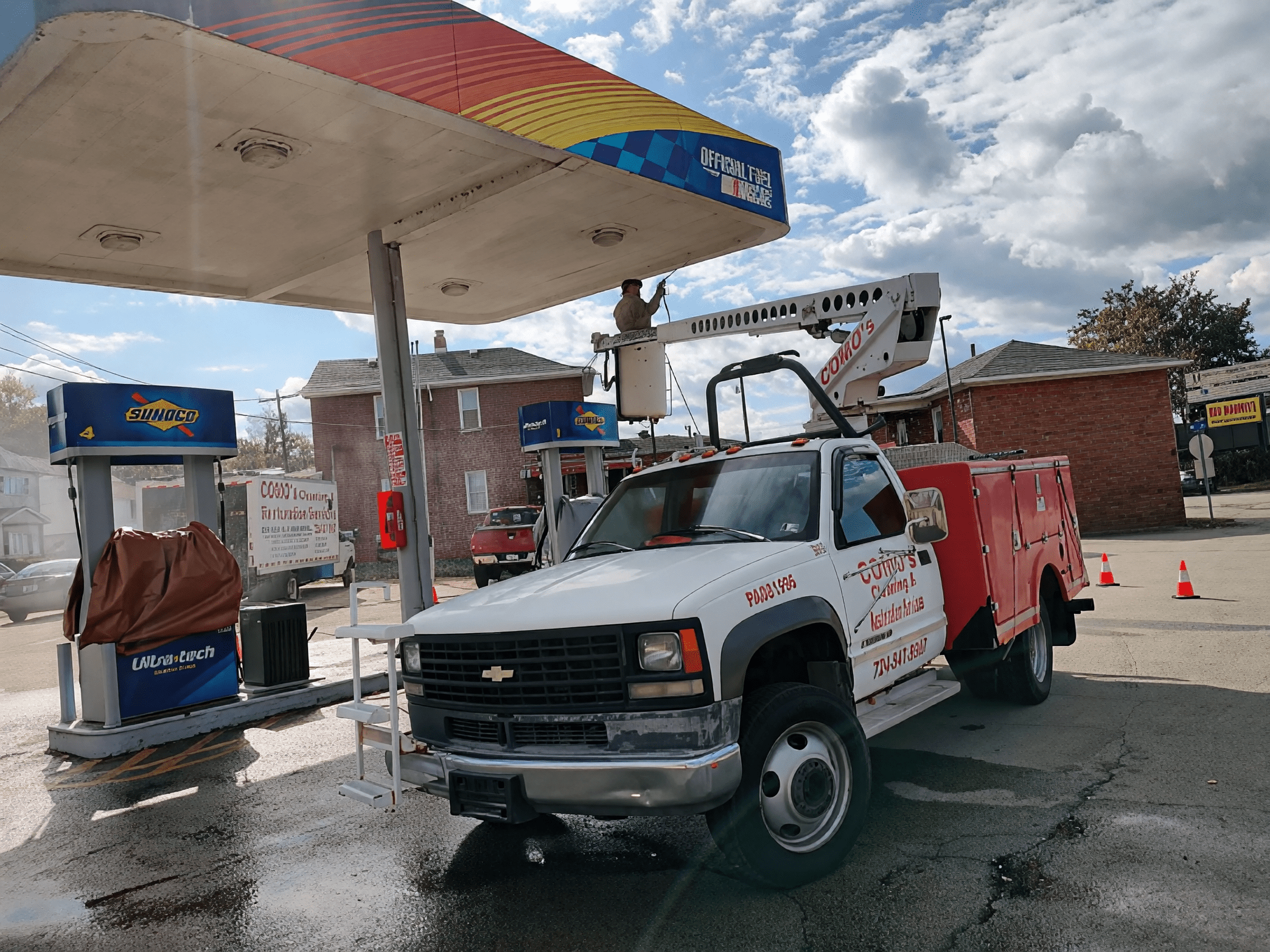 Red utility truck beneath cloudy sky