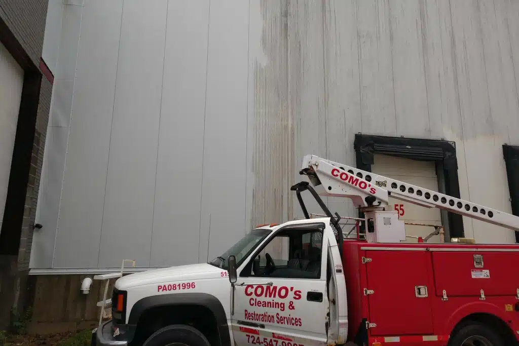 COMO's truck parked by a warehouse