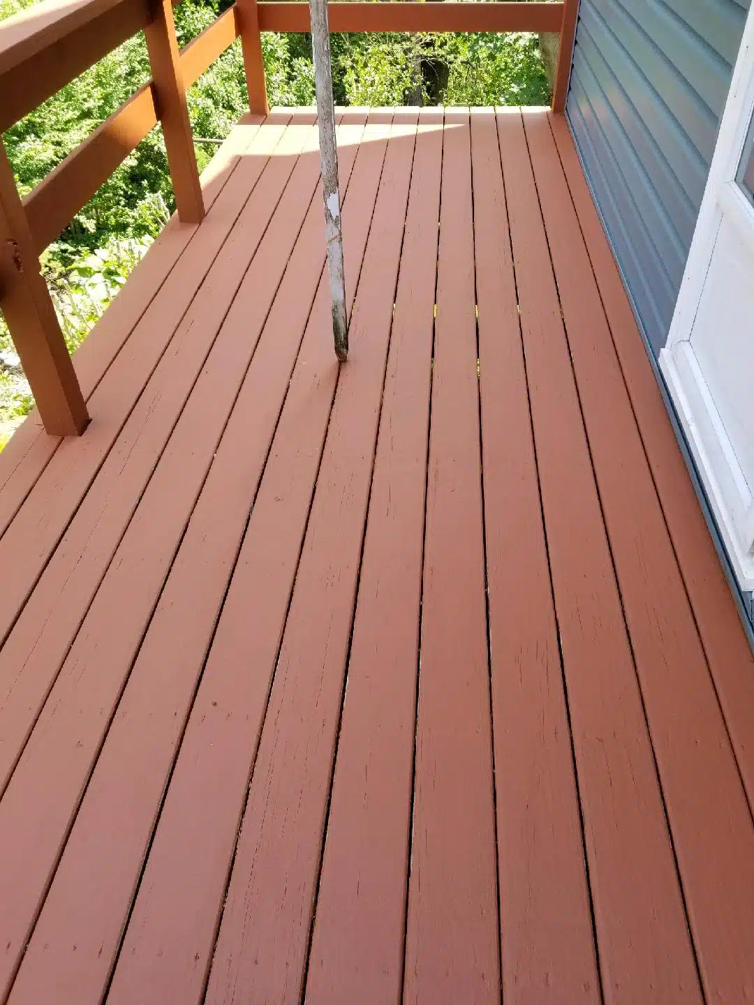 Wooden deck with railing and pole