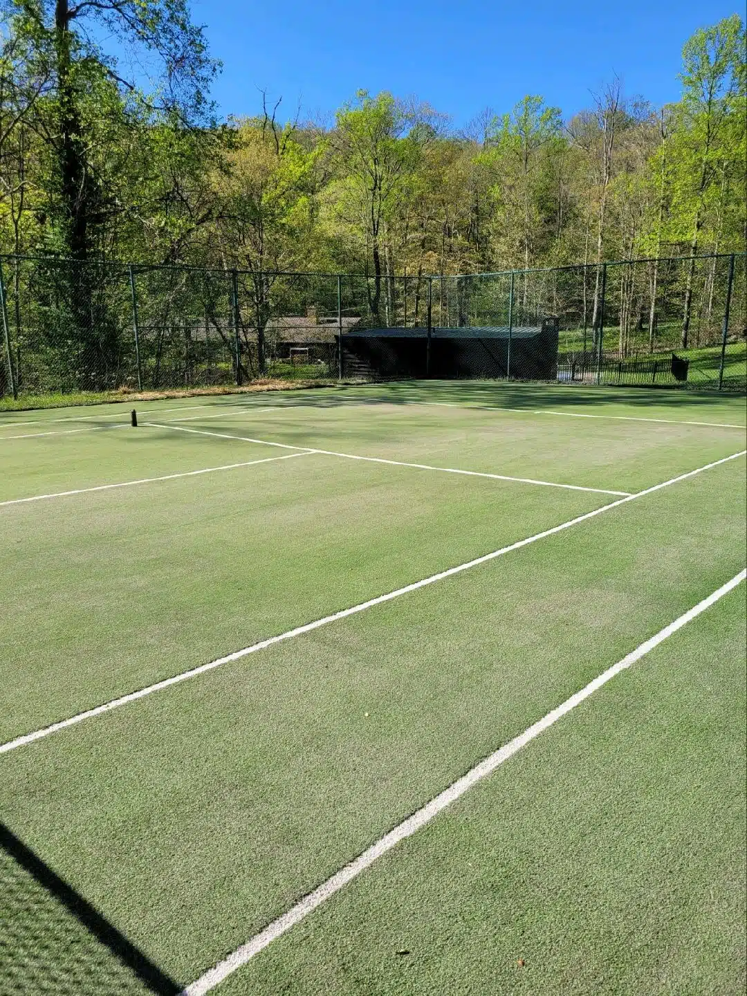 Outdoor tennis court with green surface
